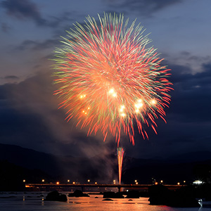 オレンジの大きな花火が上がっている写真
