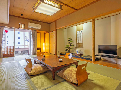 【スーペリア和室10畳】窓の外の小さな庭を眺め、ゆっくりとくつろぐ贅沢な時間。